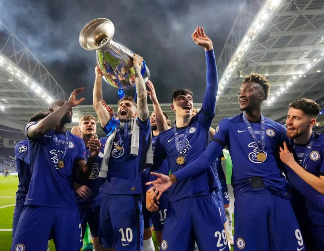 The Chelsea FC team holding a trophy